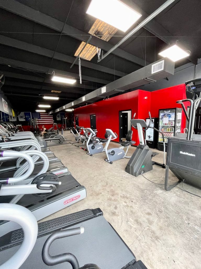 A gym filled with lots of treadmills and exercise bikes.