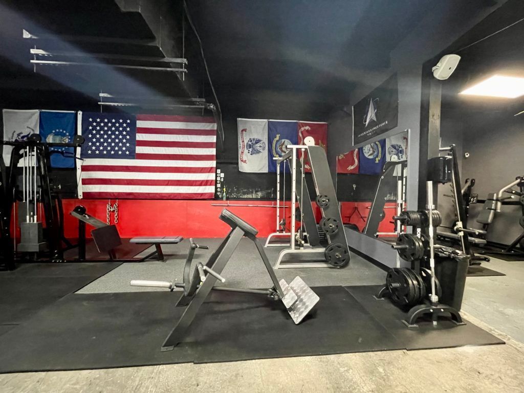 A gym with a large american flag on the wall.