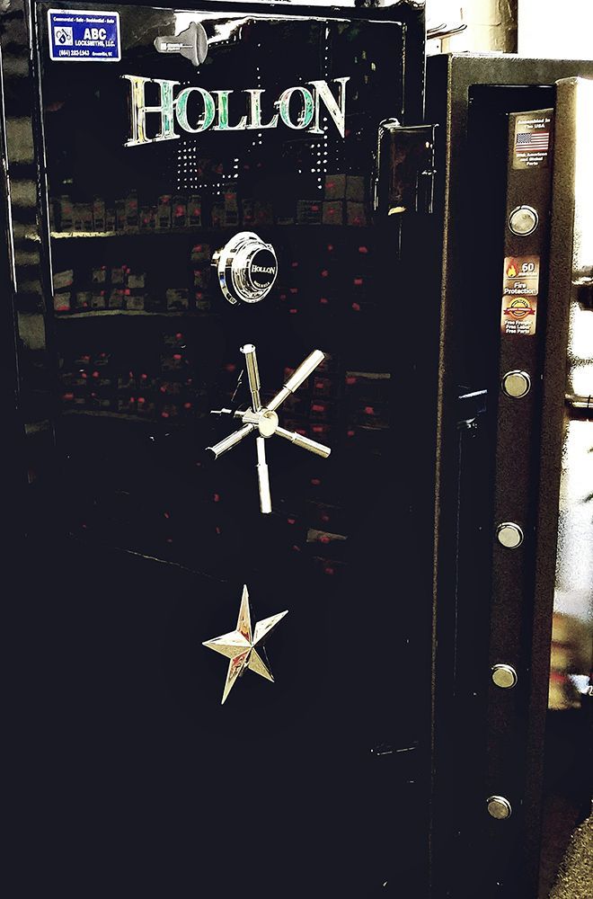 Black Hollon safe with dial, handles, and open door revealing shelves.