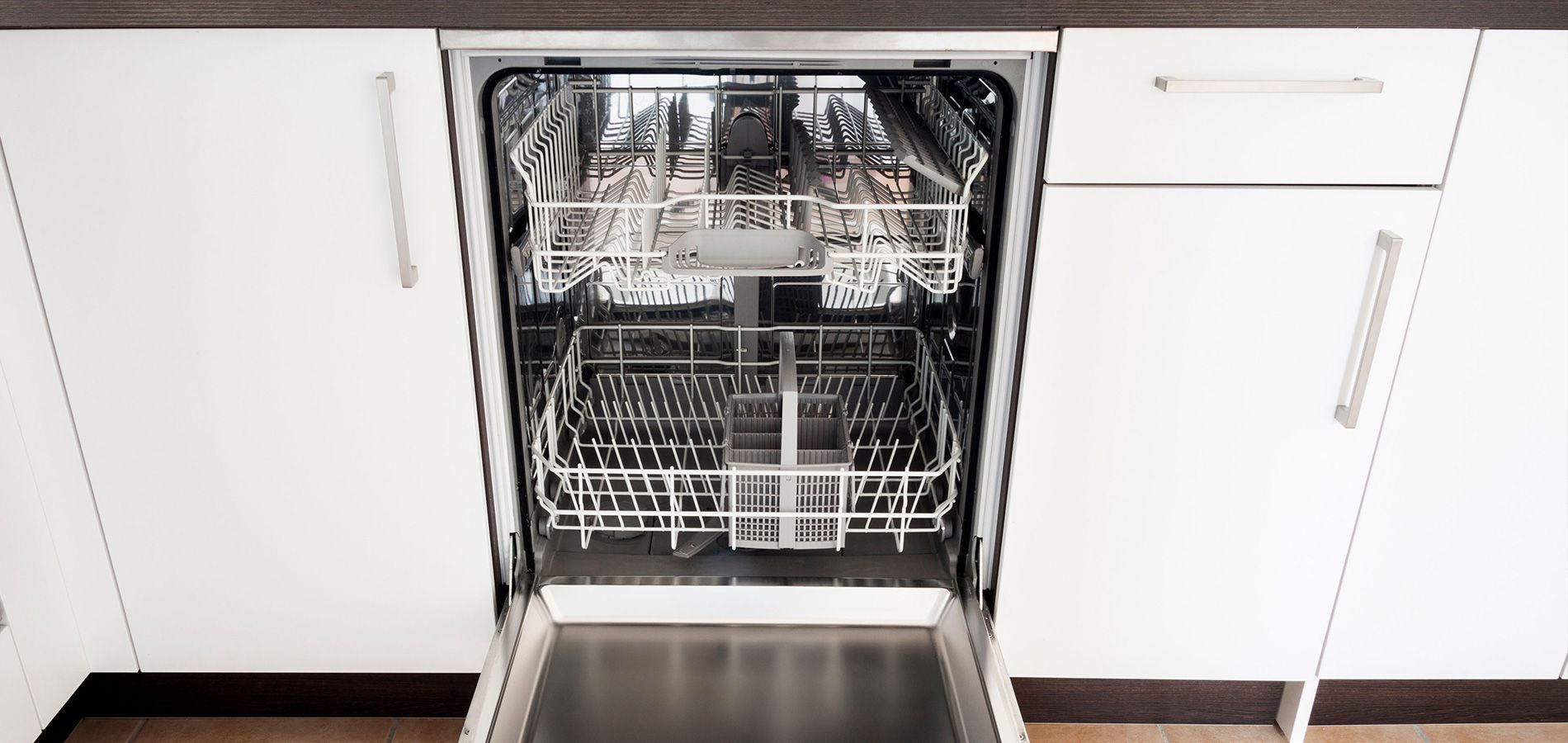 A dishwasher is open in a kitchen with the door open.