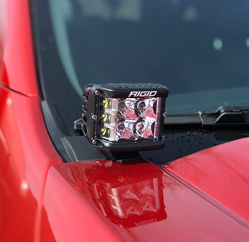 a red truck with a light on the hood .