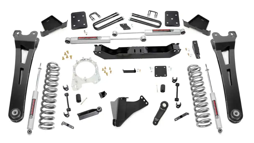 a bunch of suspension parts are sitting on top of each other on a white surface .