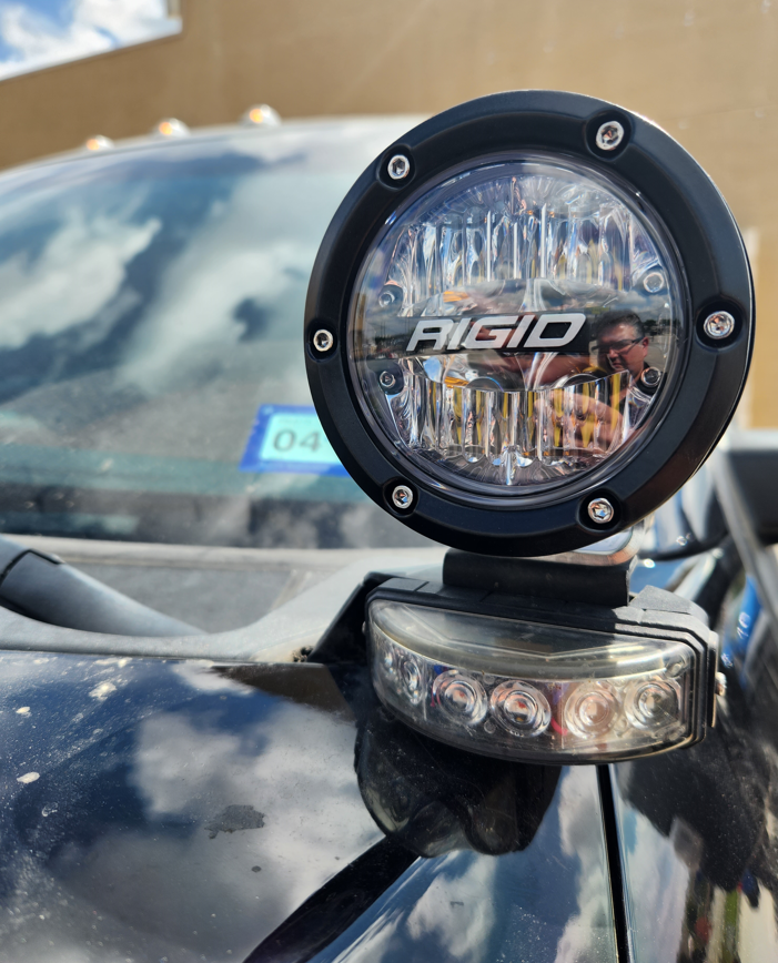 a rigid light is mounted on the hood of a car
