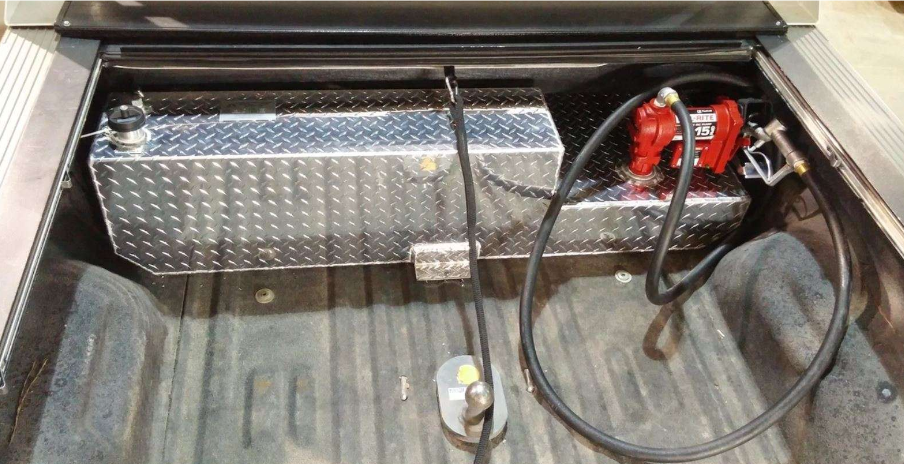 a truck bed with a fuel tank and pump in it