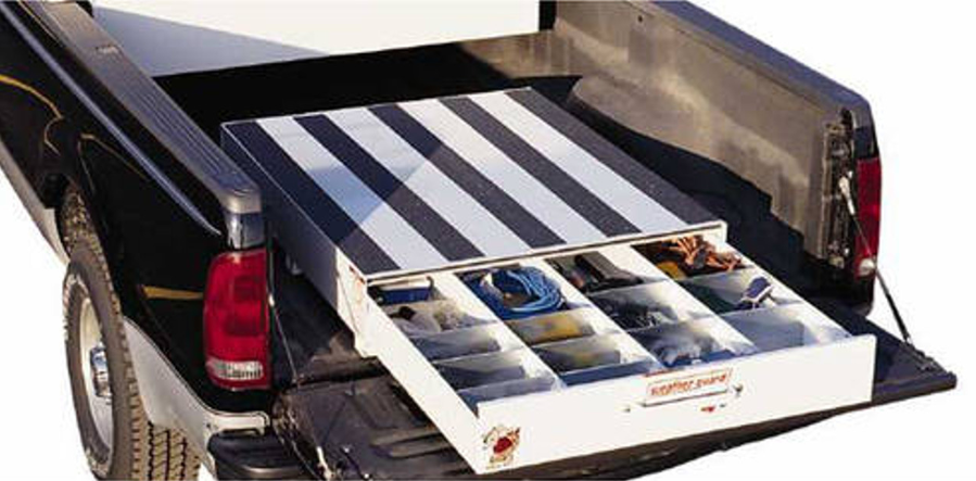the back of a truck with a striped table in the bed