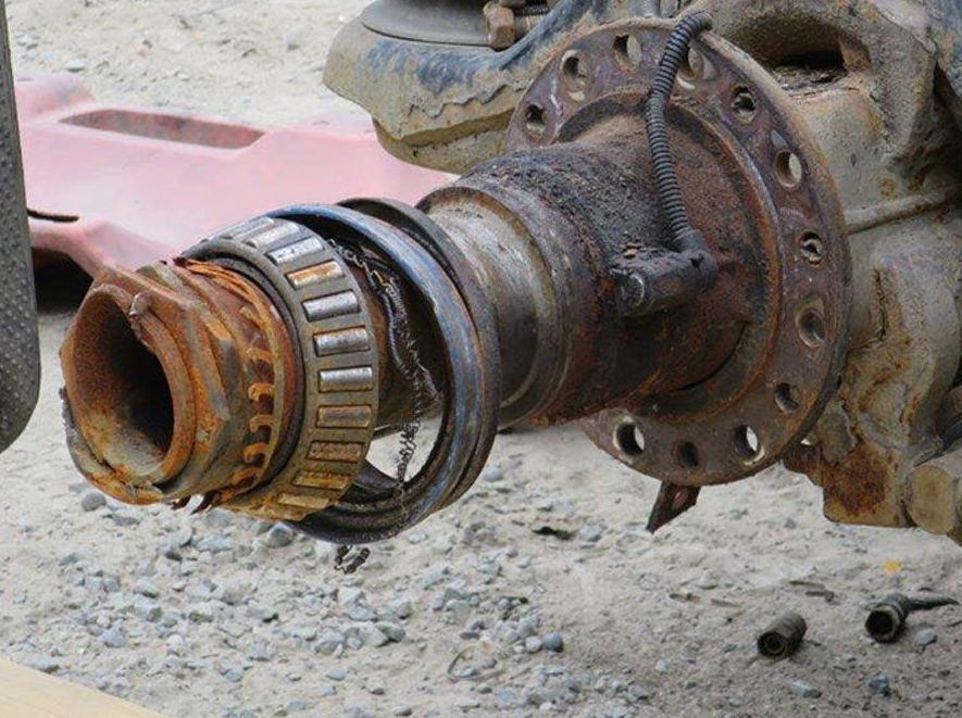 a close-up of a rusty bearing on a vehicle