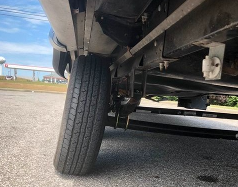 a close-up of a car's tire on a road