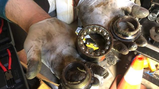 a person is holding a bunch of bearings