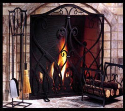 Black wrought-iron fireplace screen, matching tool set, and log holder in front of a brick fireplace with a burning fire.