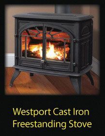 A black cast-iron freestanding stove with glowing logs inside, positioned on a hardwood floor.