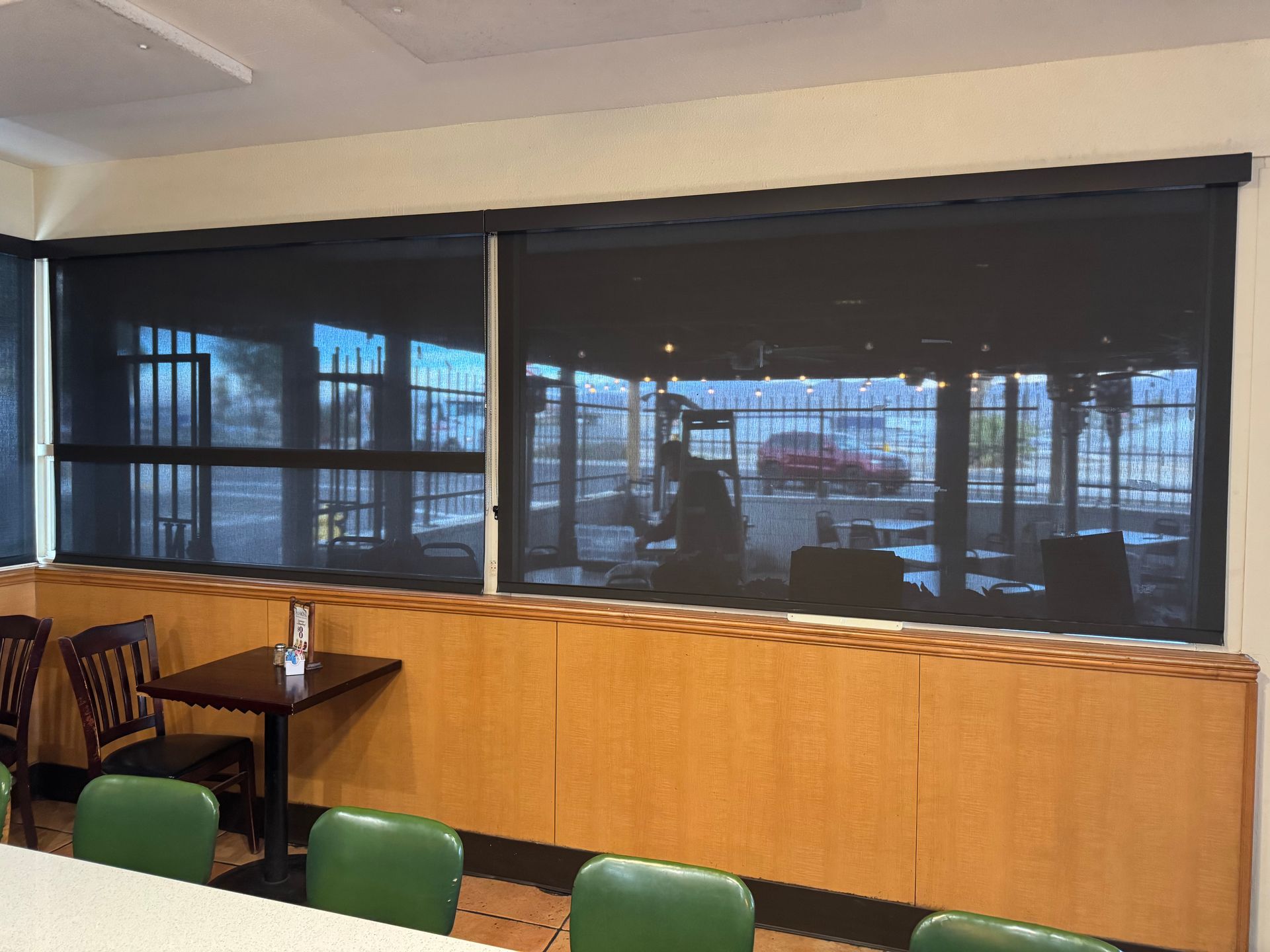 A restaurant with tables and chairs and a large window