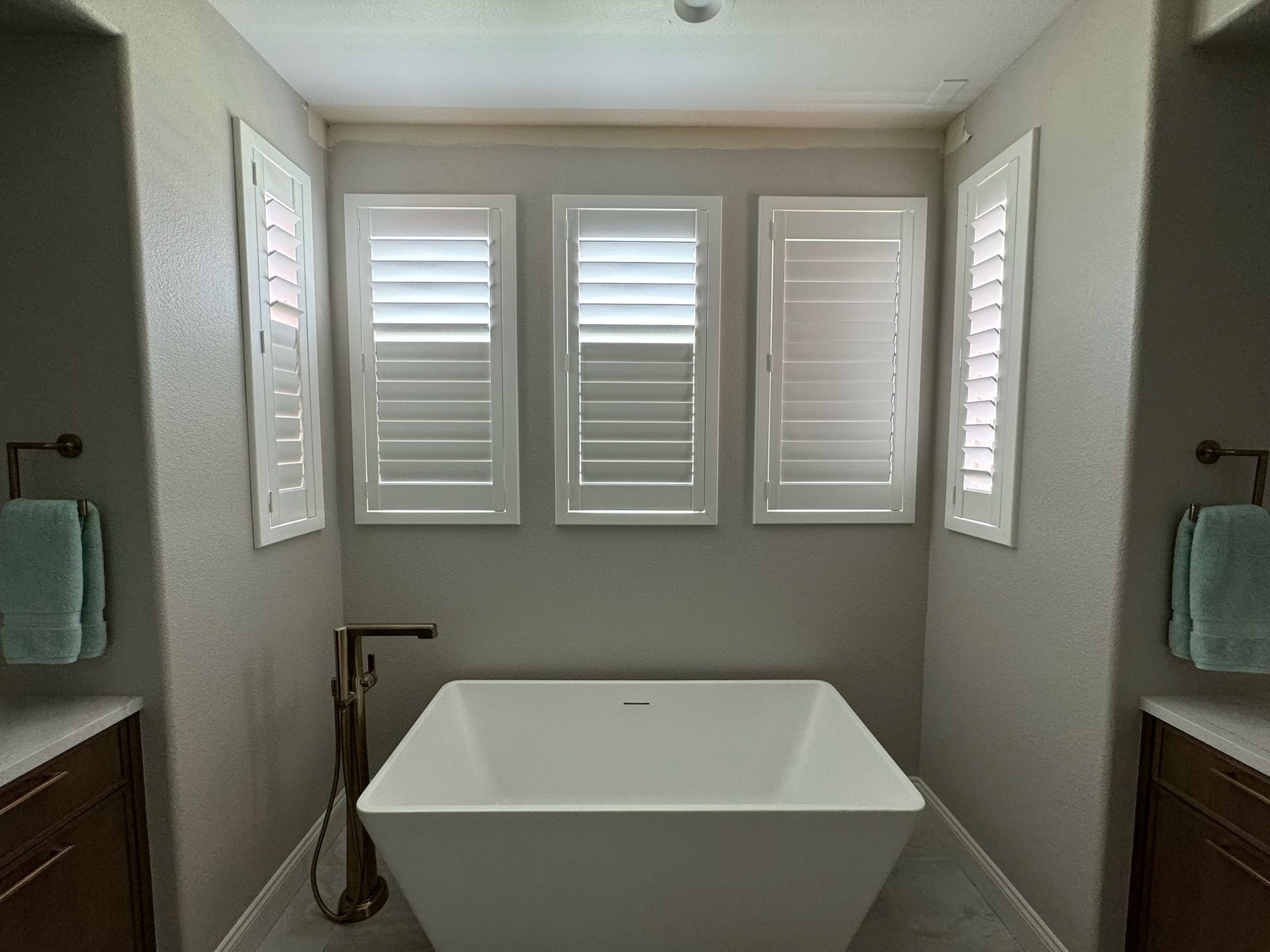 There is a bathtub in the middle of the bathroom.