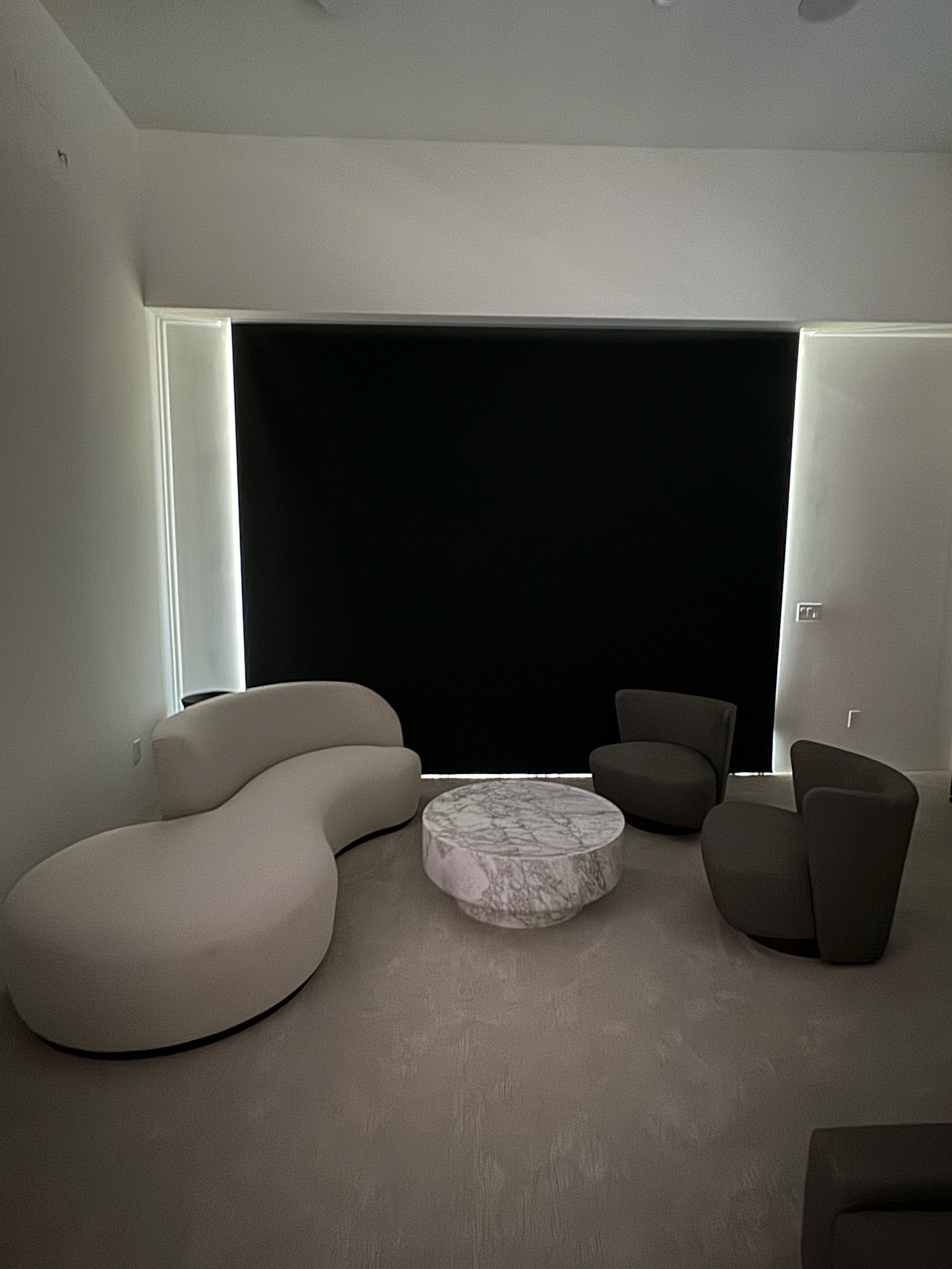 A living room with a couch, chairs, and a coffee table.