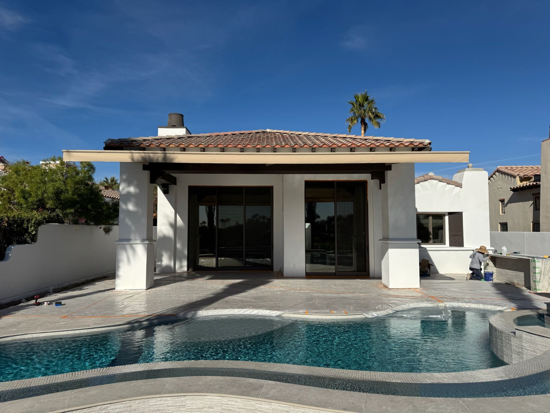 A house with a swimming pool in front of it