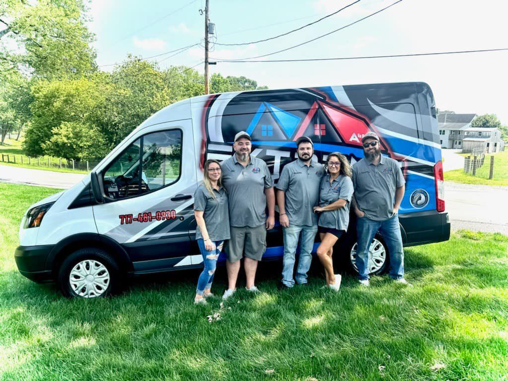 A group of people are posing for a picture in front of a van.