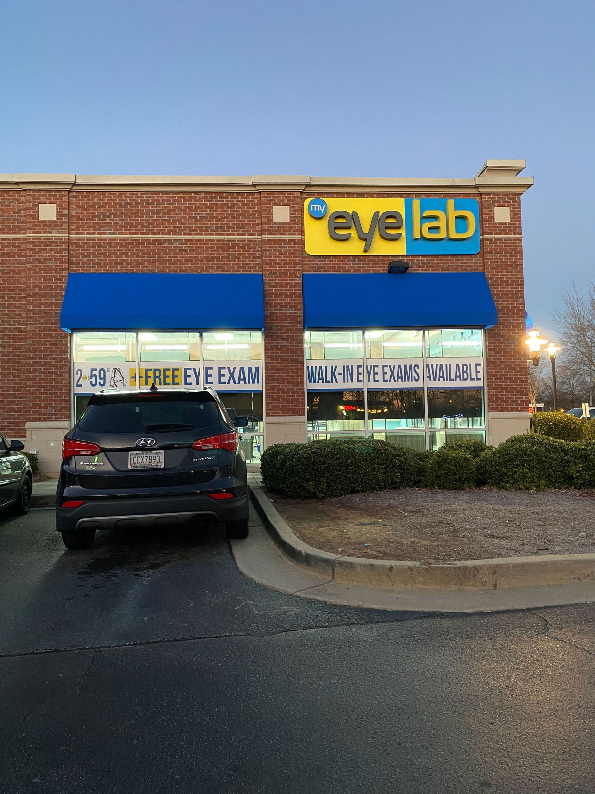 A car is parked in front of an eye lab store
