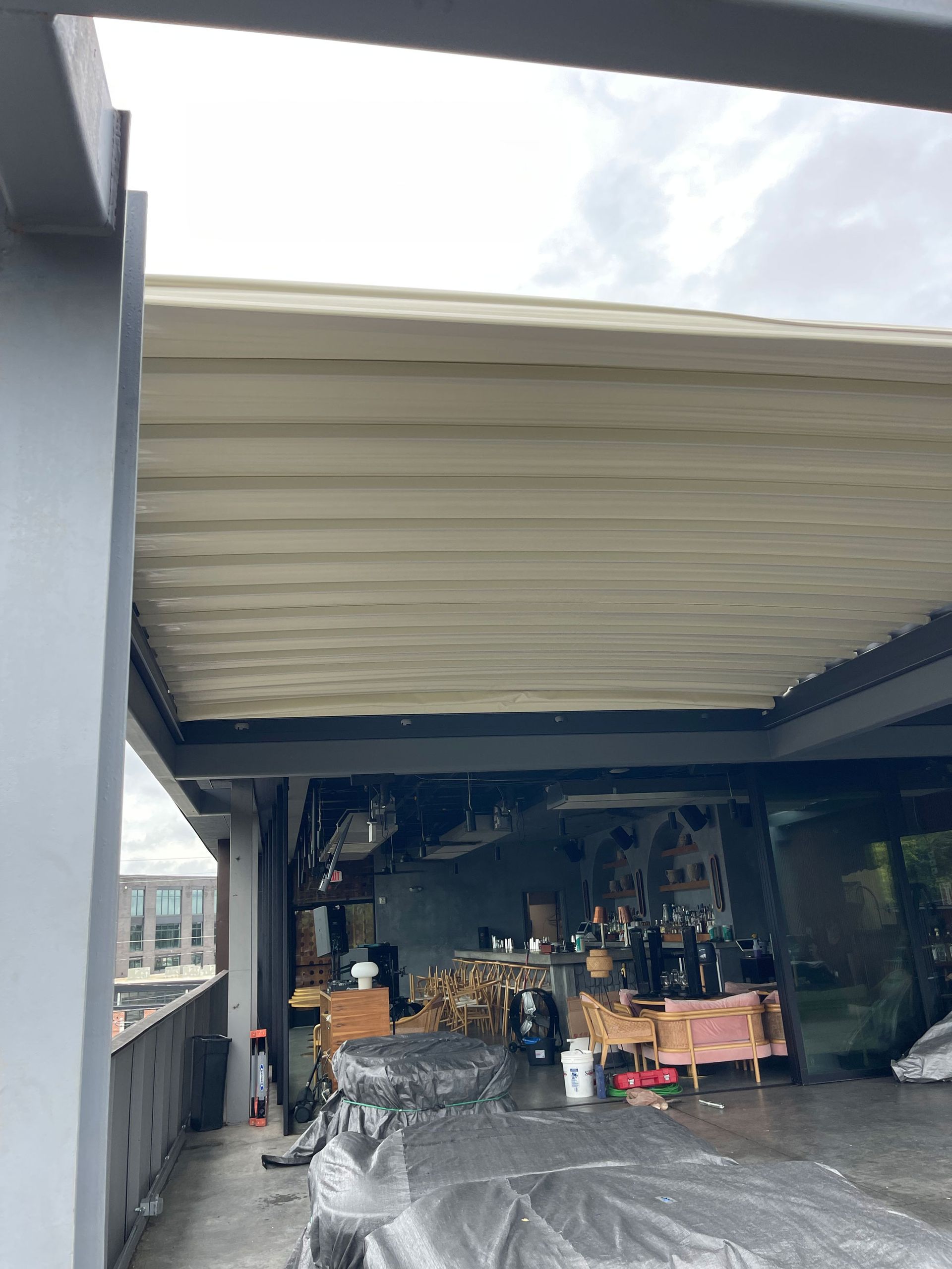 The roof of a building with a motorcycle parked underneath it.