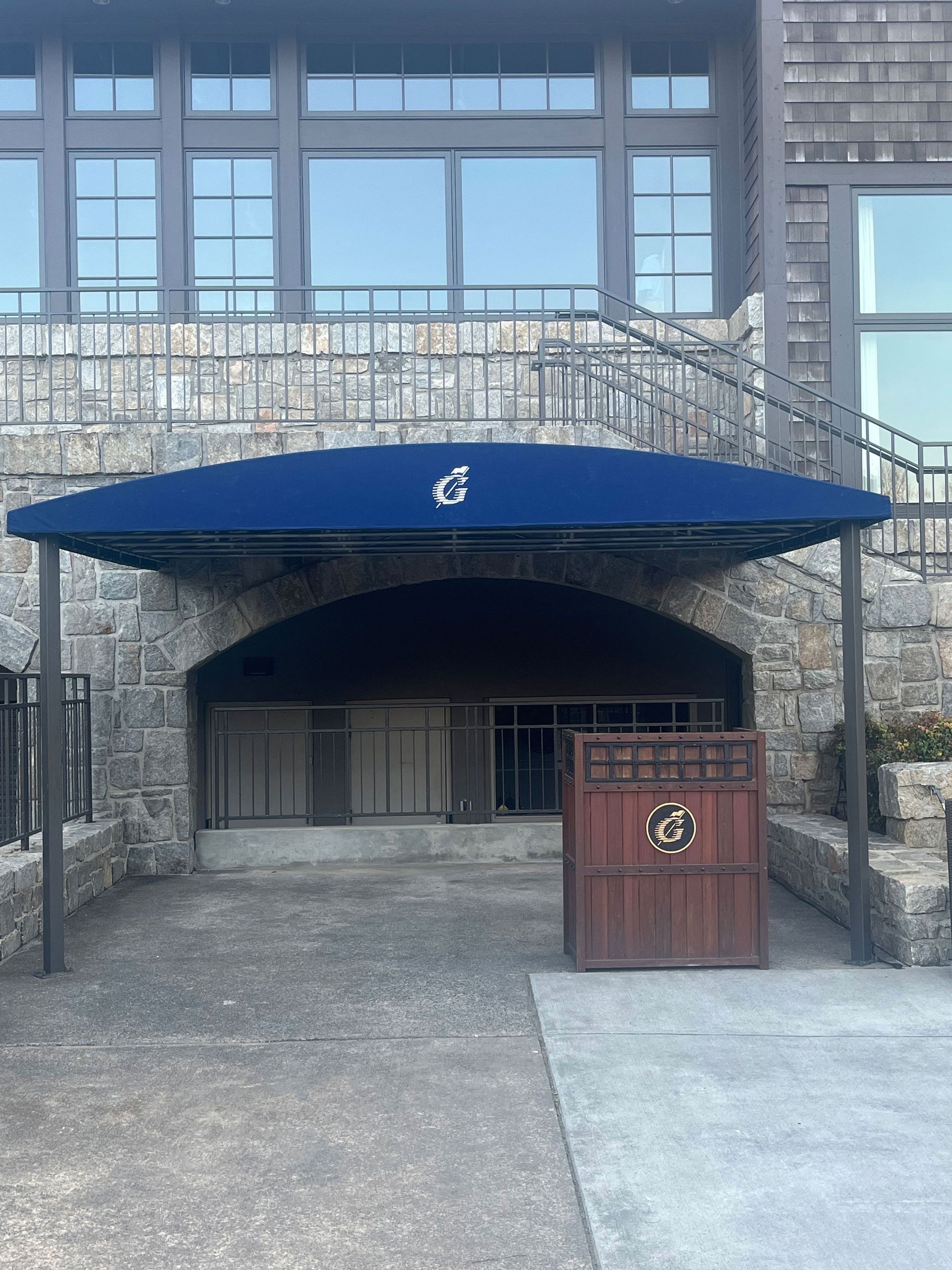 A blue awning is covering the entrance to a building