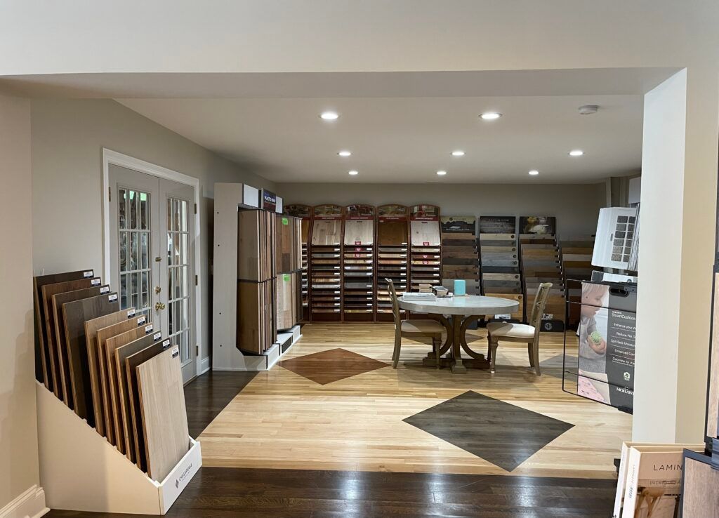 A large room with a table and chairs in it.