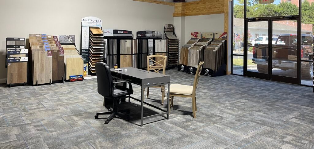 There is a table and chairs in the middle of the room.