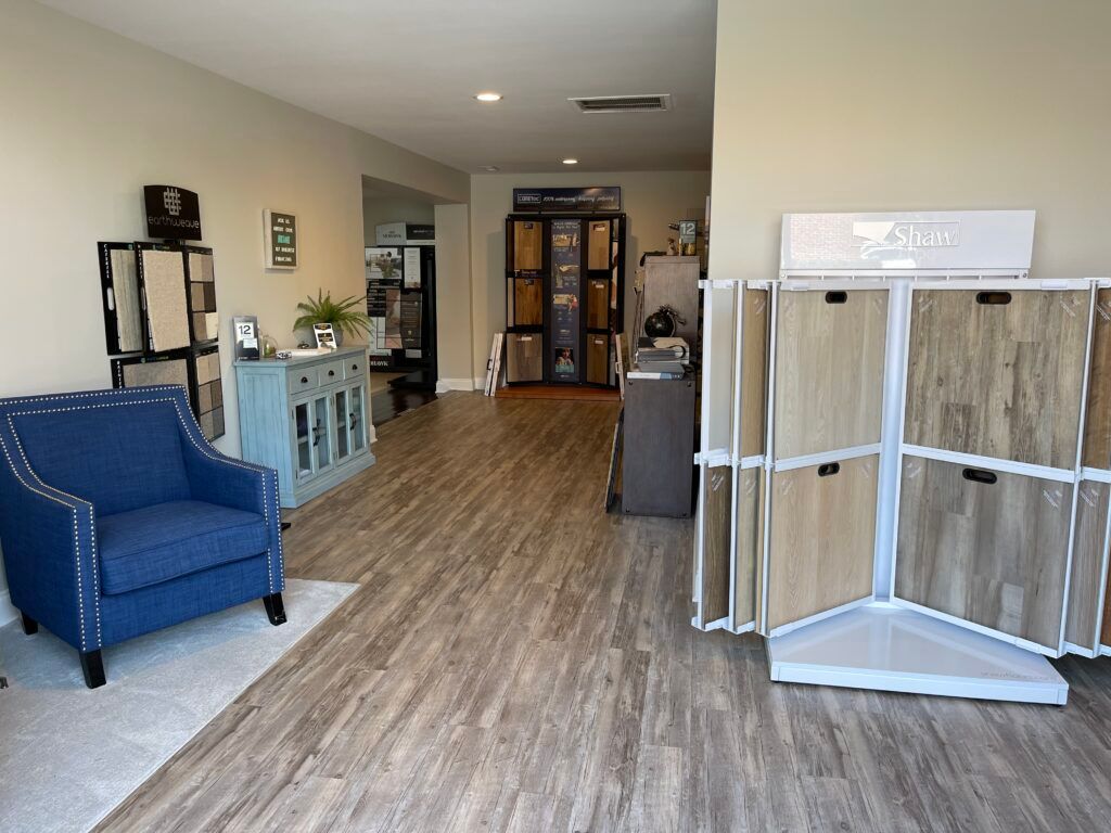 A living room with hardwood floors and a blue chair.