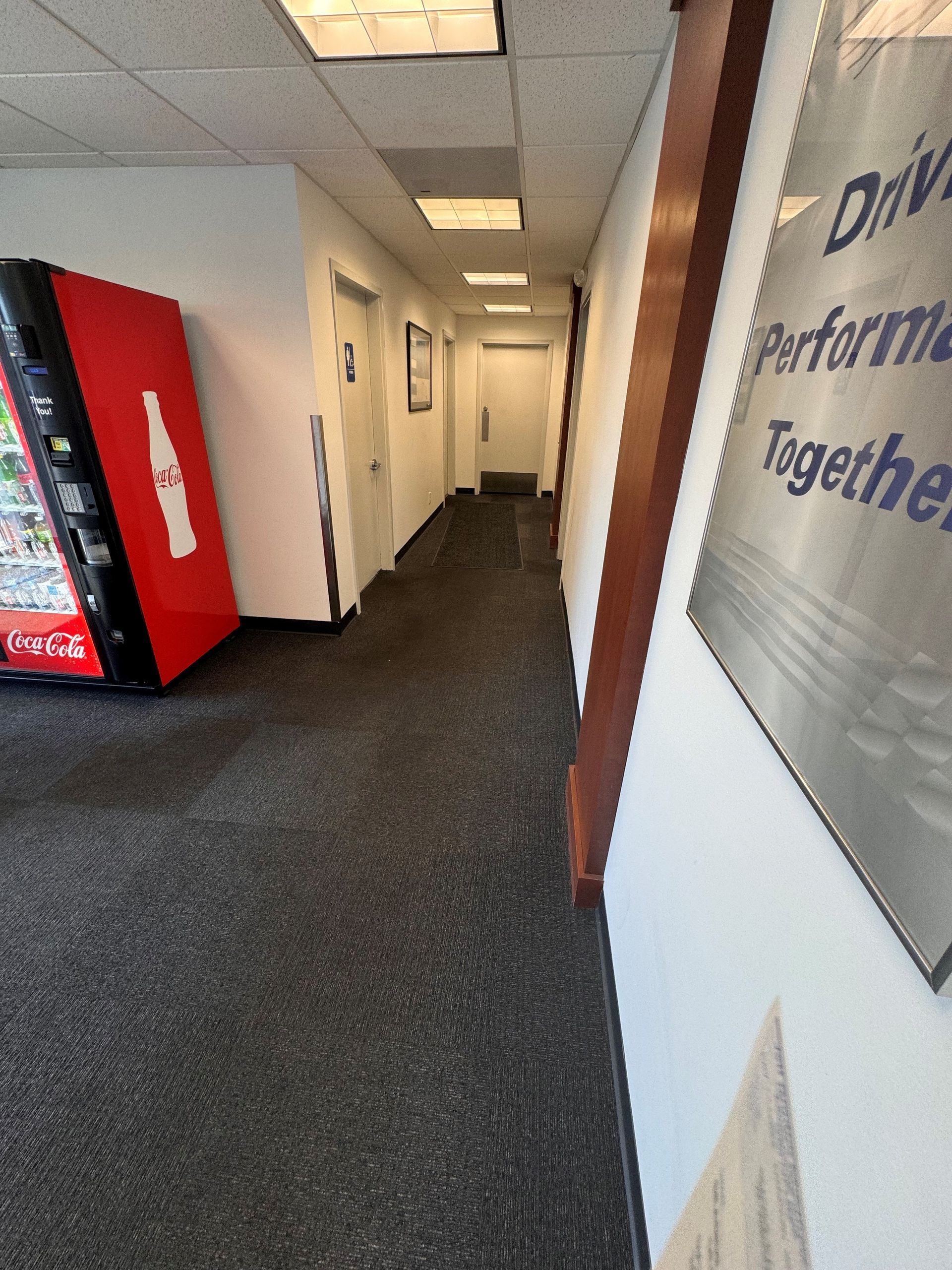 A long hallway with a coca cola vending machine