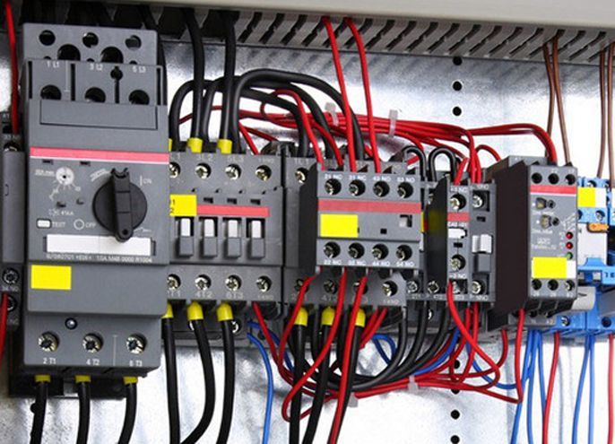 A close up of a electrical panel with a lot of wires.