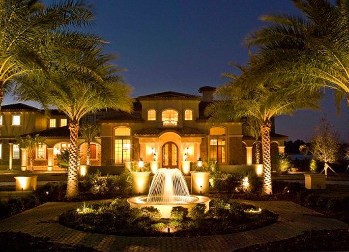 A large house with a fountain in front of it