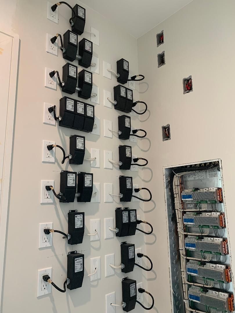 A wall with a bunch of electrical outlets on it