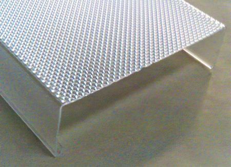 Textured silver metal step with a diamond-plate top and smooth side panel