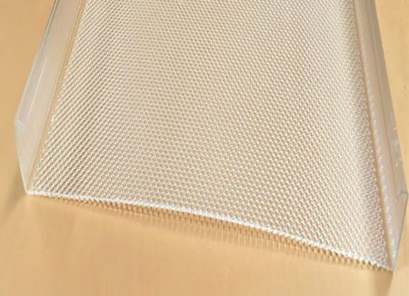 Transparent mesh laundry bag on a beige surface