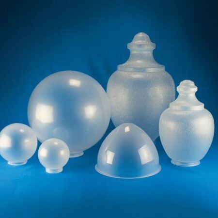 Clear and frosted glass lamp shades on a blue background
