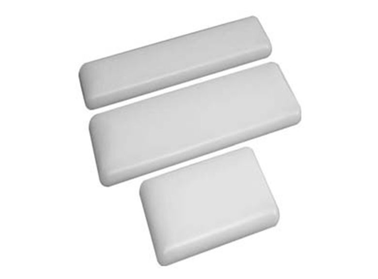 Three white foam cushioning pieces on a plain background