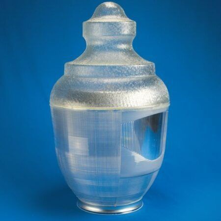 Silver decorative glass bottle with a rounded lid on a blue background