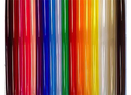 Vertical rainbow-colored translucent strips in red, pink, blue, green, yellow, orange, and brown tones