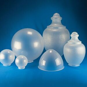 Assorted frosted and clear glass containers on a blue background
