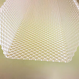 White lattice-patterned hanging fabric or lamp shade viewed from below against a pale background