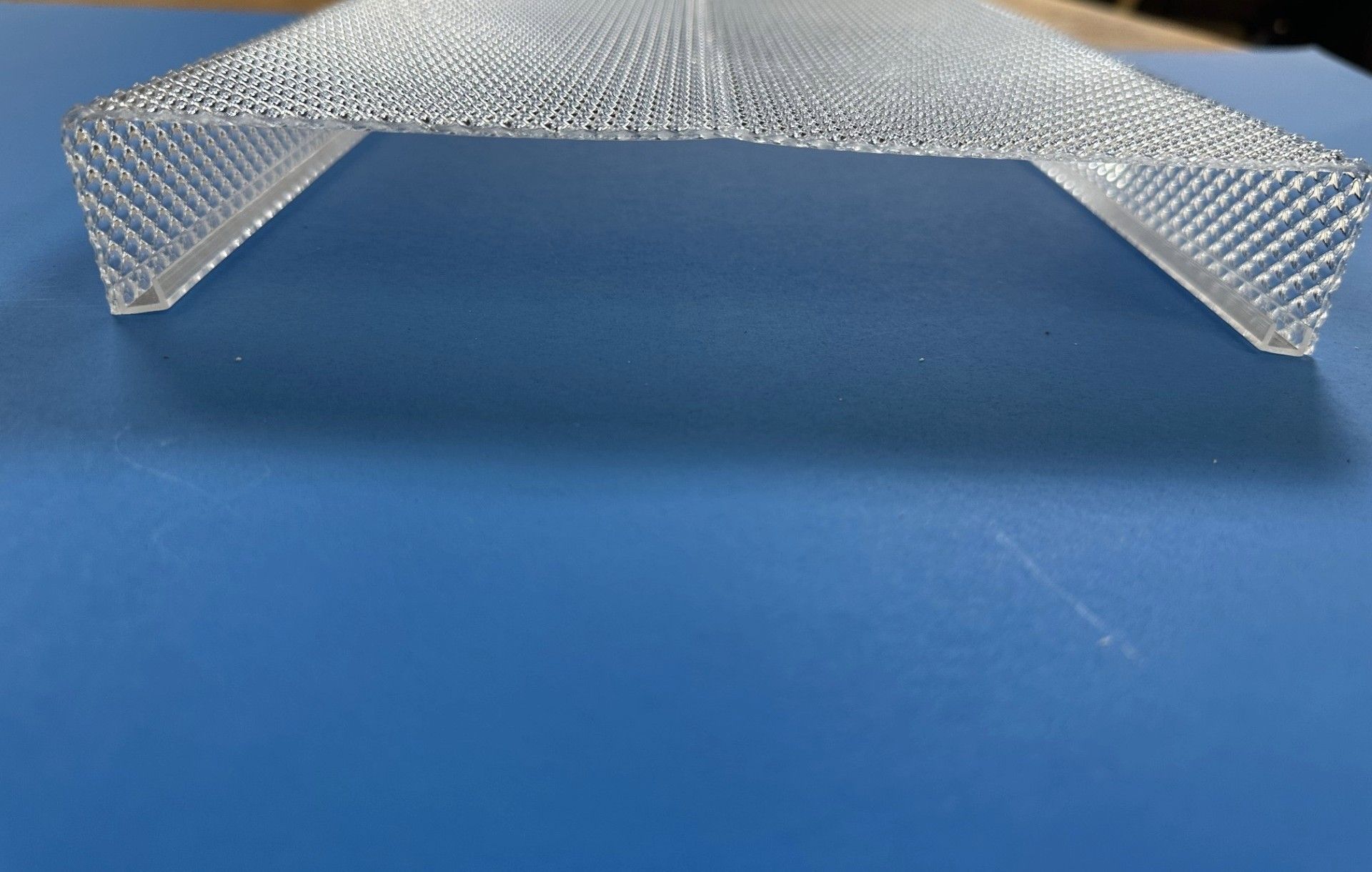 Metal mesh diffuser on blue background with Diffuser Specialists logo