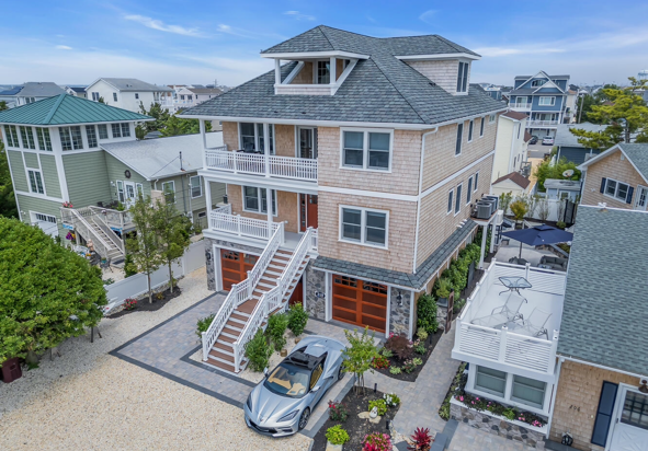 An aerial view of a large house with a car parked in front of it.