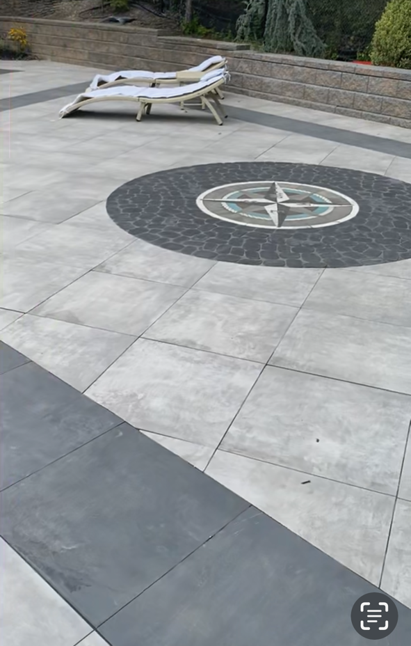 A patio with a chair and a circular design on it.