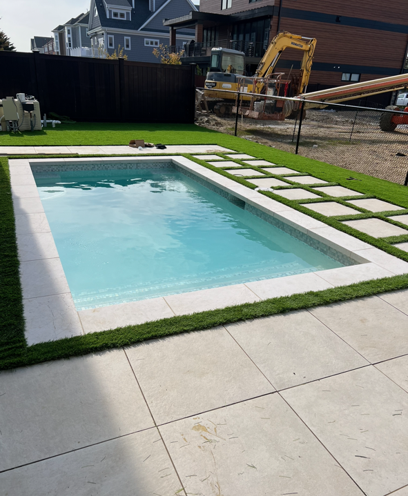 A swimming pool is being built in a backyard.