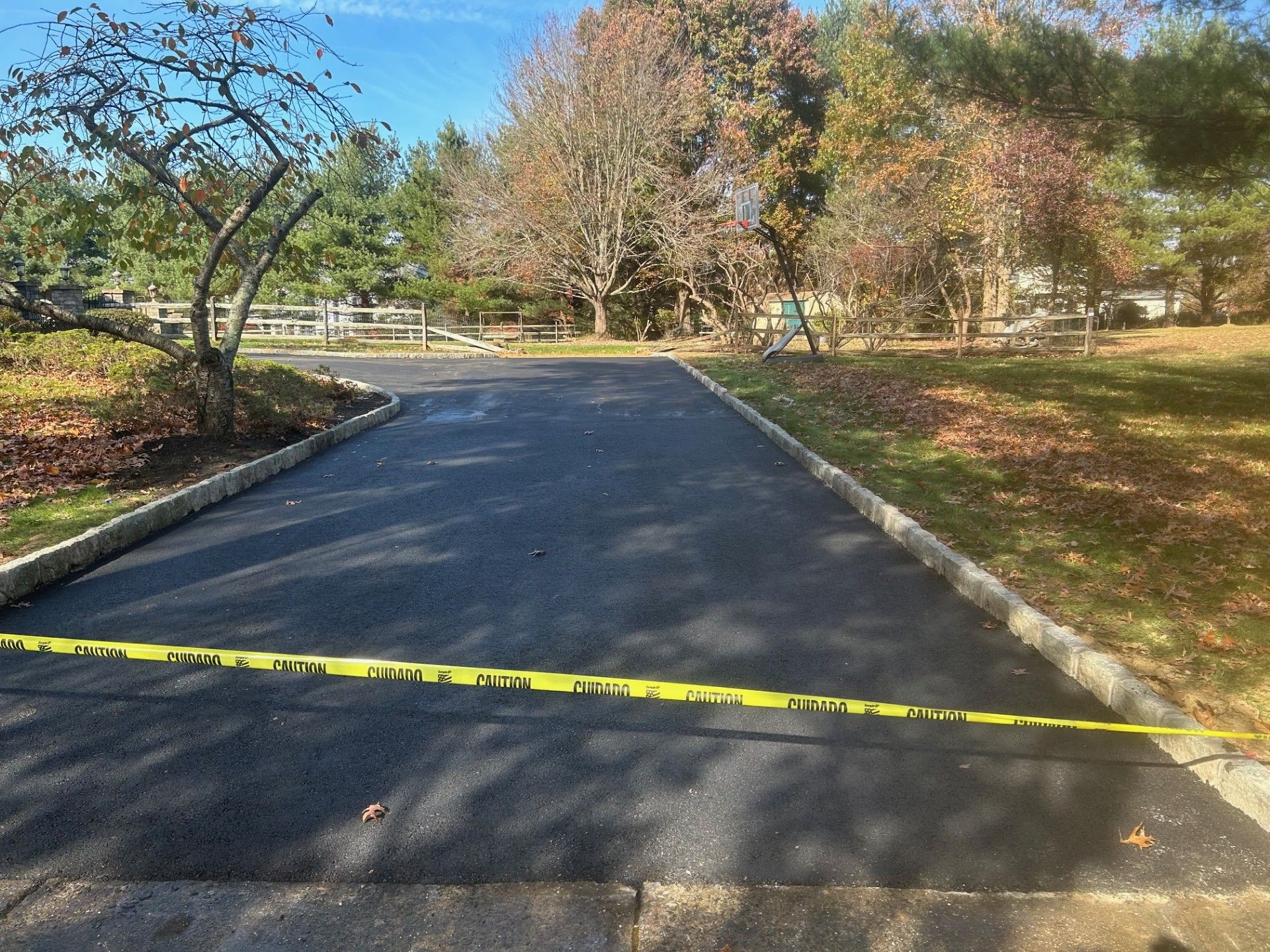 A road with a yellow tape along the side of it.