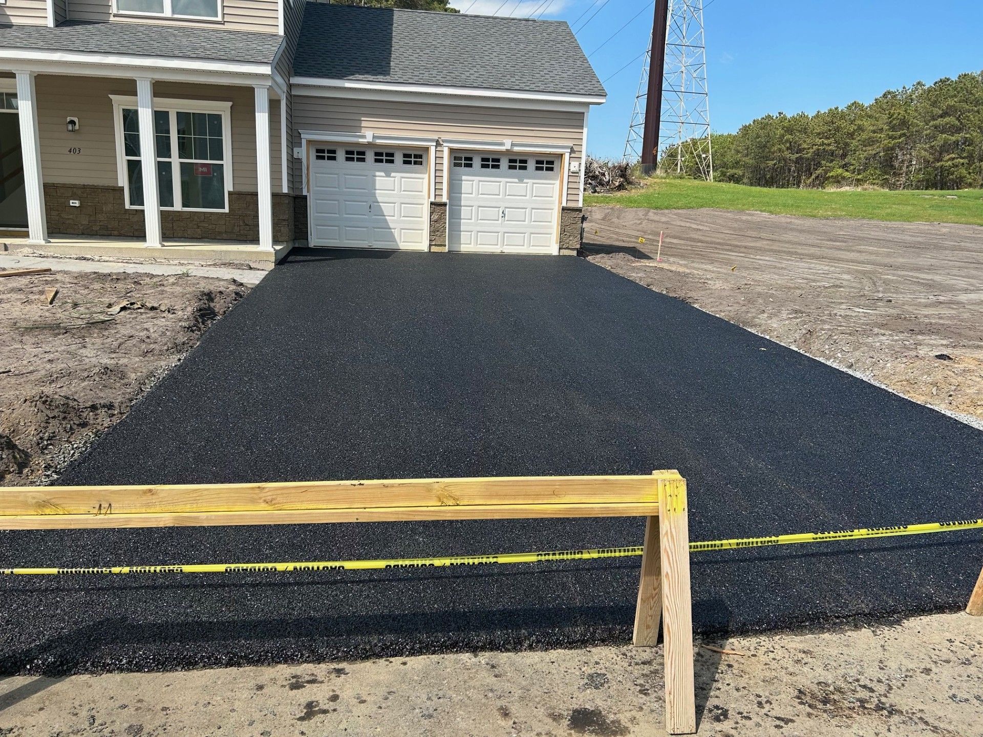 A driveway is being built in front of a house.
