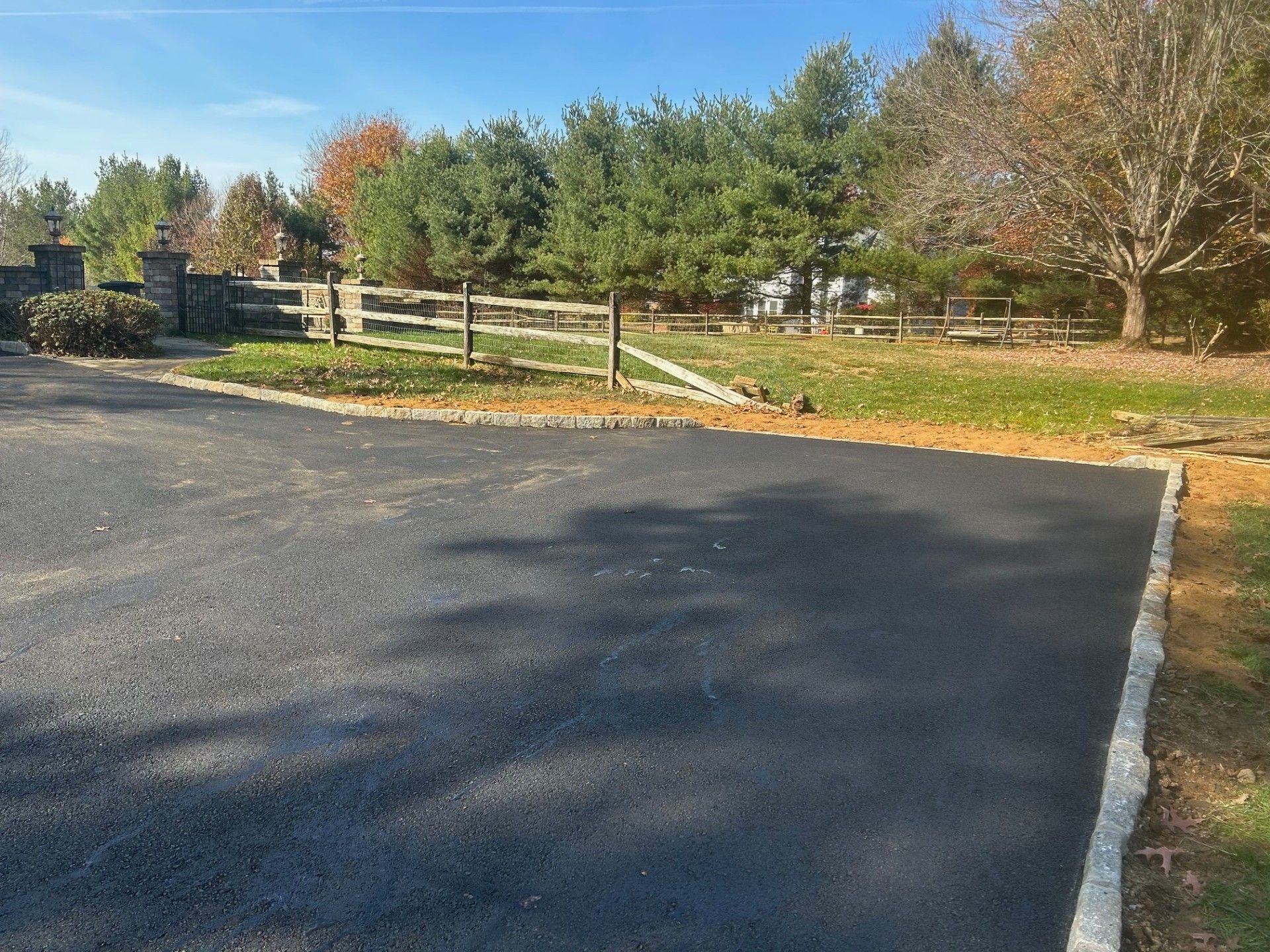 A road with a wooden fence on the side of it