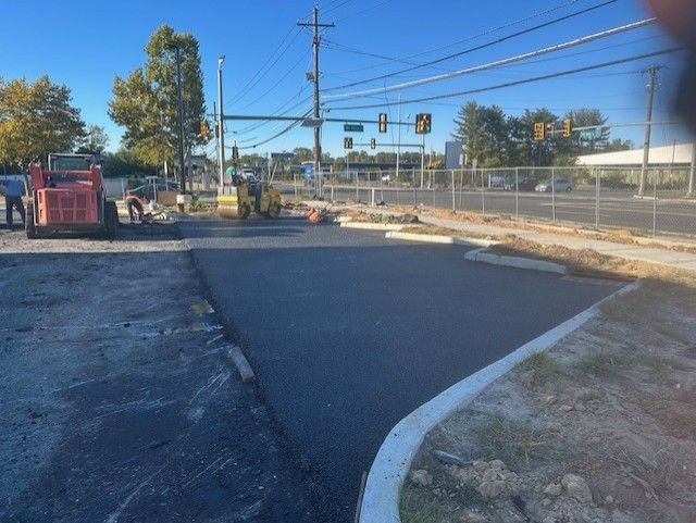 A construction site with a red bulldozer in the foreground.