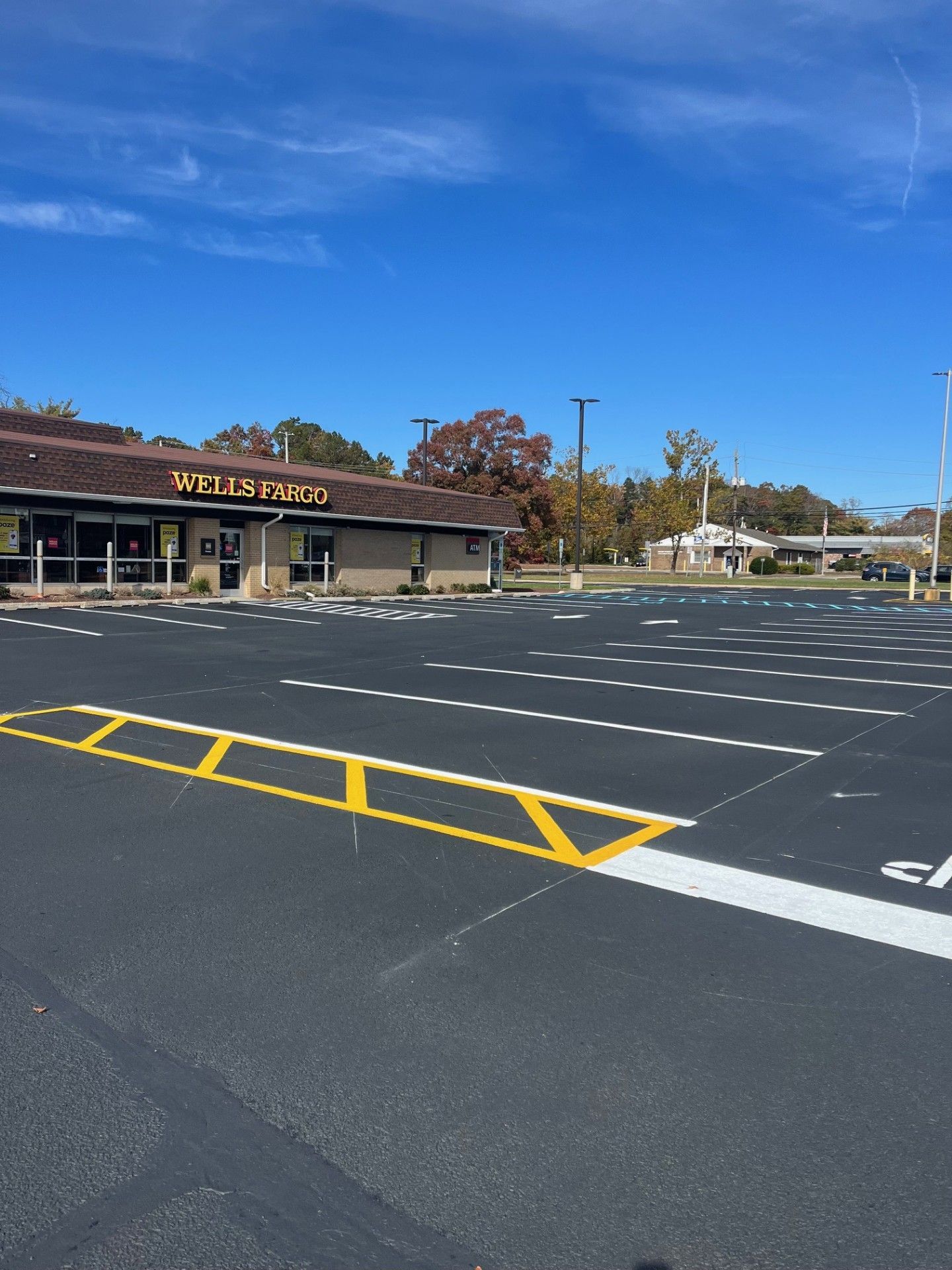 An empty parking lot in front of a Jay's Steaks restaurant.