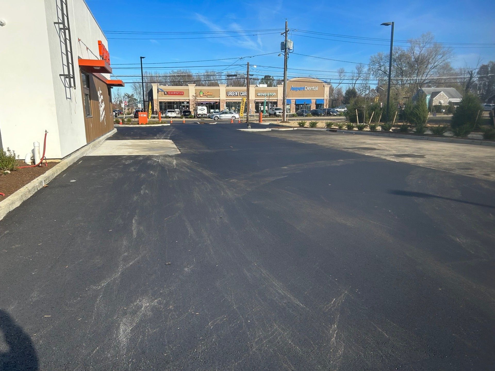 A parking lot in front of a donut shop.