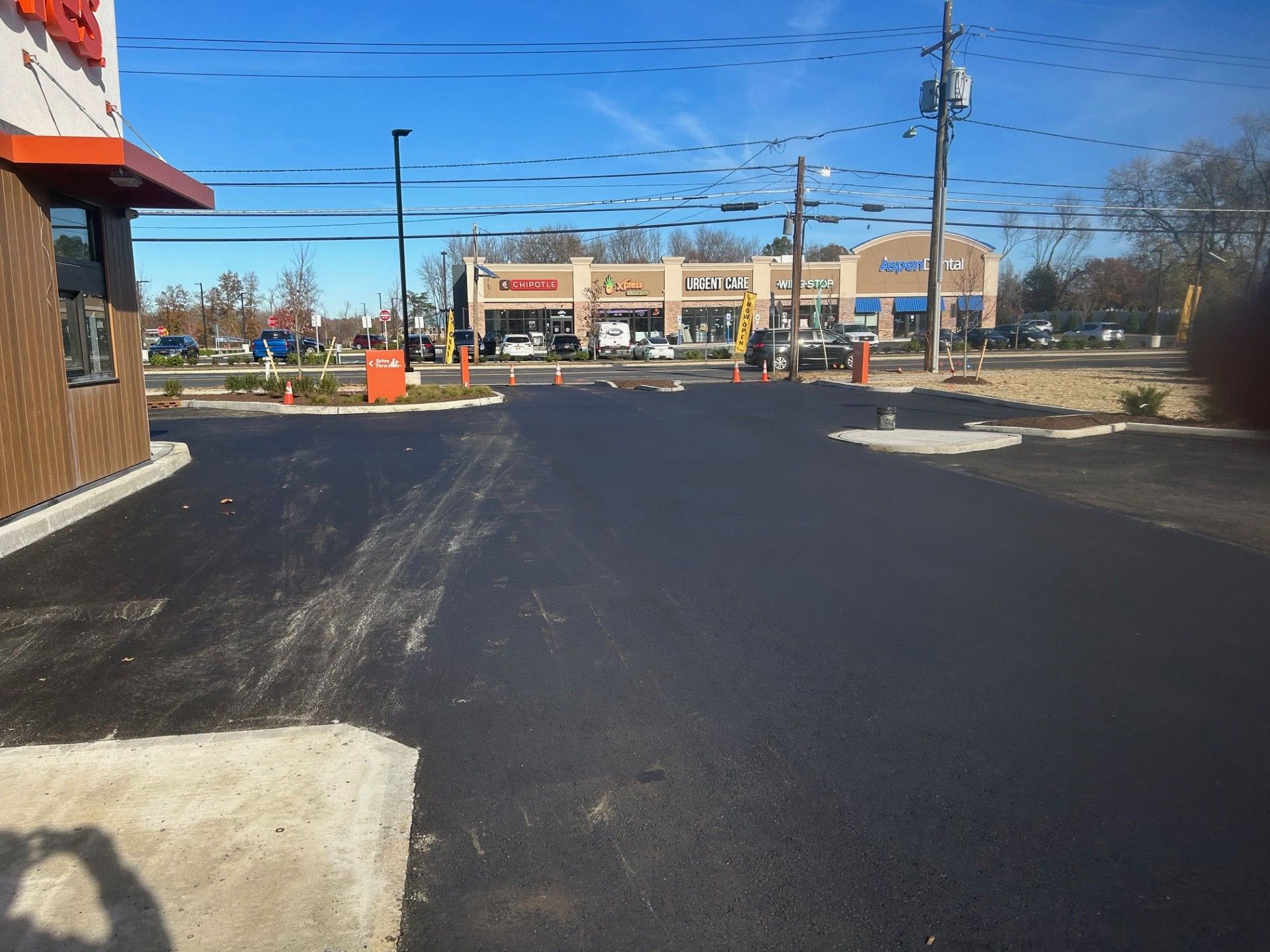 A shadow of a person taking a picture of a parking lot.