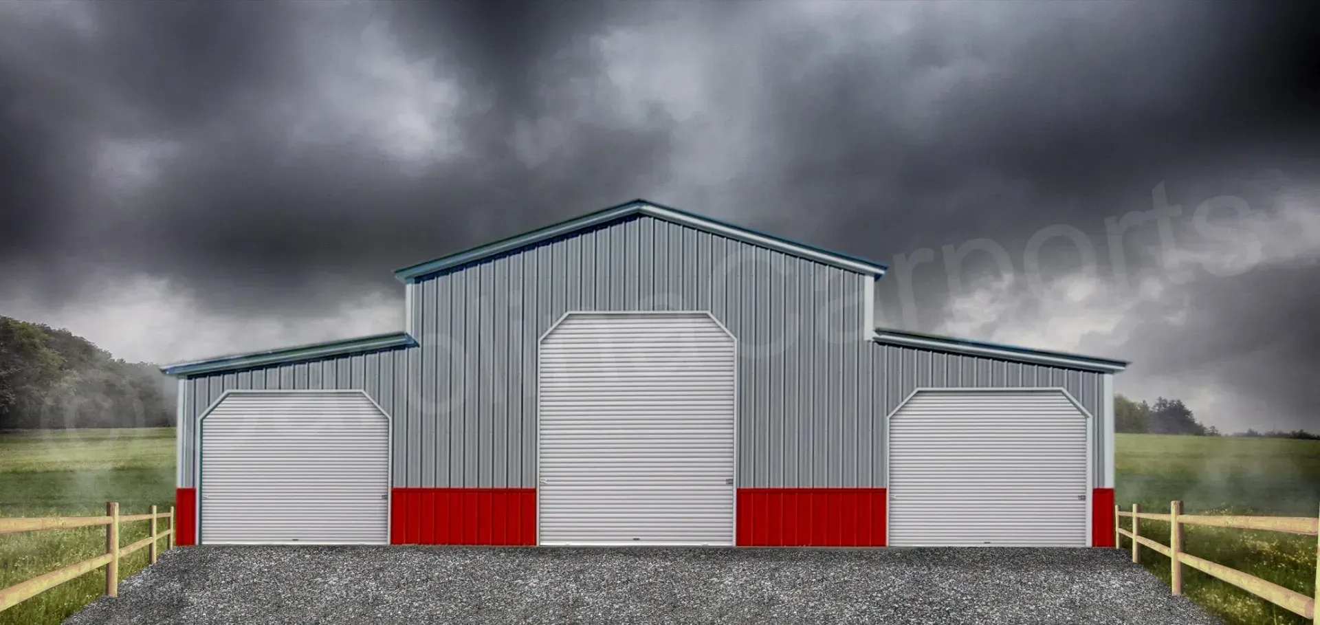 A gray barn with red trim sits under a dark, stormy sky.