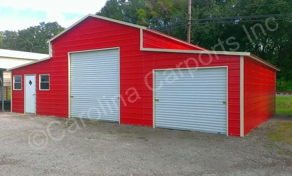 Red metal garage building with two garage doors and a white door.